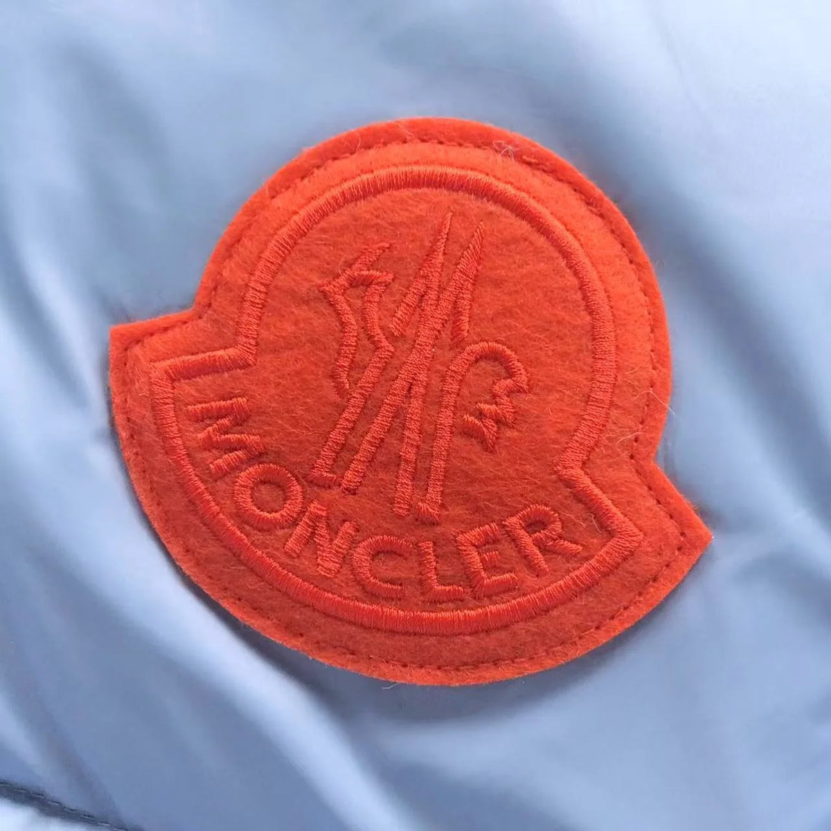 Moncler Ice Blue Hooded Puffer Jacket – Orange Logo Patch & Contrast Hood Lining
